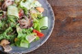 Healthy delicious sea food salad with octopus mussels squid etc top view on wooden table with copy space Royalty Free Stock Photo