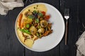 Healthy and delicious vegetarian food. Baked potatoes, carrots, green peas, chanterelles with mozzarella cheese. Edible forest