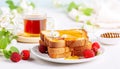 healthy and delightful breakfast featuring honey drizzled on toast and a steaming cup of tea.