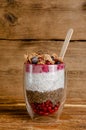 Healthy dessert chia yogurt pudding on rustic wooden background.