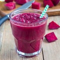 Healthy detox beetroot, carrot, apple and lemon juice smoothie in glass on wooden table, square format Royalty Free Stock Photo