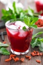 Healthy detox drink with goji berries infused in water with ice, cold refreshing beverage close-up Royalty Free Stock Photo