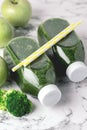 Healthy Detox Green Smoothie with Green Apples and Ripe Broccoli in Bottles Healthy Diet Food Drink Vertical Above White