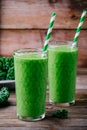 Healthy detox green smoothie with kale in a glass on wooden background Royalty Free Stock Photo