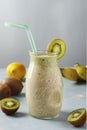 Healthy detox smoothie kiwi, banana, lemon in glass jar on light blue background with fresh ingredients, Diet and weight loss Royalty Free Stock Photo