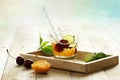 Healthy detox water, glass of cherry, orange and lime on wooden tray Royalty Free Stock Photo