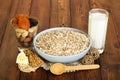 Healthy diet for adults: oatmeal, milk, nuts, dried fruits on background dark wood