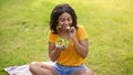 Healthy diet concept. Beautiful black girl eating fresh vegetable salad at park Royalty Free Stock Photo