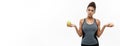 Healthy and diet concept - Beautiful sporty African American make a decision between donut and green apple. Isolated on Royalty Free Stock Photo