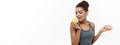 Healthy and diet concept - Beautiful sporty African American make a decision between donut and green apple. Isolated on Royalty Free Stock Photo