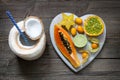 Healthy diet concept with coconut milk and tropical fruit heart