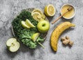 Healthy diet concept. Smoothie detox drink ingredients - kale, apple, banana, honey, ginger, lemon on a grey background, top view