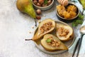 Healthy diet dessert. Baked pears with hazelnuts, honey and granola on a slate Royalty Free Stock Photo