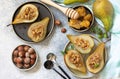 Healthy diet dessert. Baked pears with hazelnuts, honey and granola on a slate, stone or concrete background. Royalty Free Stock Photo