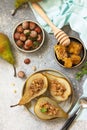 Healthy diet dessert. Baked pears with hazelnuts, honey and granola on a slate Royalty Free Stock Photo