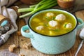 Healthy and diet food. Soup with meatballs and bulgur on a wooden table.