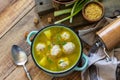 Healthy and diet food. Soup with meatballs and bulgur on a wooden table. Copy space.