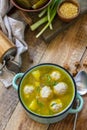 Healthy and diet food. Soup with meatballs and bulgur on a wooden table. Copy space.