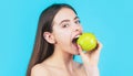 Healthy diet food. Stomatology concept. Woman with perfect smile holding apple, blue background Royalty Free Stock Photo
