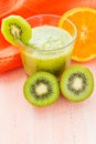 Healthy diet fruit juice kiwi orange wooden table Royalty Free Stock Photo