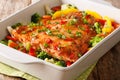 Healthy diet meal baked salmon fillet with vegetables and herbs close-up in a baking dish. horizontal