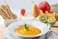 Healthy diet menu with pumpkin soup, kefir, sesame seed crackers and fresh fruit
