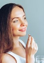 Healthy Diet Nutrition. Portrait Of Beautiful Smiling Young Woman Taking Vitamin Pill. Royalty Free Stock Photo