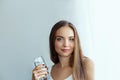 Healthy Diet Nutrition. Portrait Of Beautiful  Young Woman Taking Vitamin Pill looking in windows. Royalty Free Stock Photo