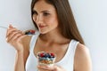 Healthy Diet Nutrition. Woman Eating Yogurt, Berries And Cereal Royalty Free Stock Photo