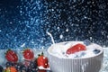 Milk splash close up of falling berries in a grey plate of milk. Strawberries and blueberries multivitamin cocktail. Healthy diet. Royalty Free Stock Photo