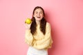 Healthy diet, people and lifestyle concept. An apple day keeps doctor away, girl holding delicious fruit and smiling Royalty Free Stock Photo