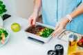 Healthy diet plan for weight loss, daily ready meal menu. Close up Woman weighing lunch box cooked in advance,ready to Royalty Free Stock Photo