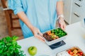 Healthy diet plan for weight loss, daily ready meal menu. Close up Woman weighing lunch box cooked in advance,ready to Royalty Free Stock Photo