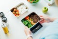 Healthy diet plan for weight loss, daily ready meal menu. Close up Woman weighing lunch box cooked in advance,ready to Royalty Free Stock Photo