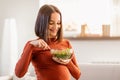 pregnant young woman eating healthy fresh salad at home Royalty Free Stock Photo