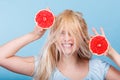 Woman holding red grapefruit having crazy windblown hair Royalty Free Stock Photo