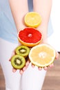 Woman holding fruits kiwi. orange, lemon and grapefruit Royalty Free Stock Photo