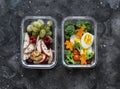 Healthy diet snack, breakfast lunch box on dark background, top view. Boiled egg, fresh vegetables and fruits - tasty healthy food