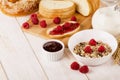 Healthy dietary breakfast with muesli, milk, fresh raspberries,