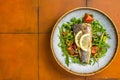 Healthy diner with sea bass fillet and vegetable salad, seabass fish. Orange background. Top view. Copy space Royalty Free Stock Photo