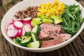 Buddha bowl lunch with grilled beef steak and quinoa, corn, avocado, cucumber Royalty Free Stock Photo