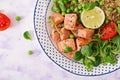 Healthy dinner. Slices of grilled salmon, quinoa, green peas, tomato, lime and lettuce leaves. Royalty Free Stock Photo