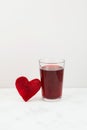 Healthy drink with beetroot juice. Glass of red beverage. Slice of beet heart shaped. Fermented homemade drink Royalty Free Stock Photo