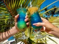 Healthy drink on a Caribbean beach. Pineapple and coconut handheld on the beach