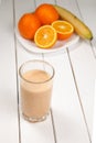 Healthy drink orange and banana smoothies on wooden table