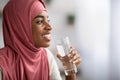 Healthy Drink. Smiling Black Muslim Lady Holding Glass With Clean Mineral Water Royalty Free Stock Photo