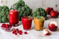 Healthy drinks. raspberry fresh smoothie in glass and bottle and peach juice on white wooden background Royalty Free Stock Photo