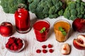 Healthy drinks. raspberry fresh smoothie in glass and bottle and peach juice on white wooden background Royalty Free Stock Photo