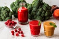 Healthy drinks. raspberry fresh smoothie in glass and bottle and peach juice on white wooden background Royalty Free Stock Photo