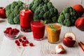 Healthy drinks. raspberry fresh smoothie in glass and bottle and peach juice on white wooden background Royalty Free Stock Photo